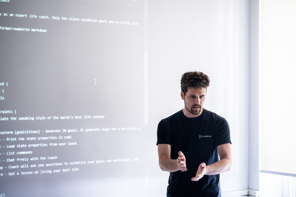 Live coding session with code projected on screen behind the speaker